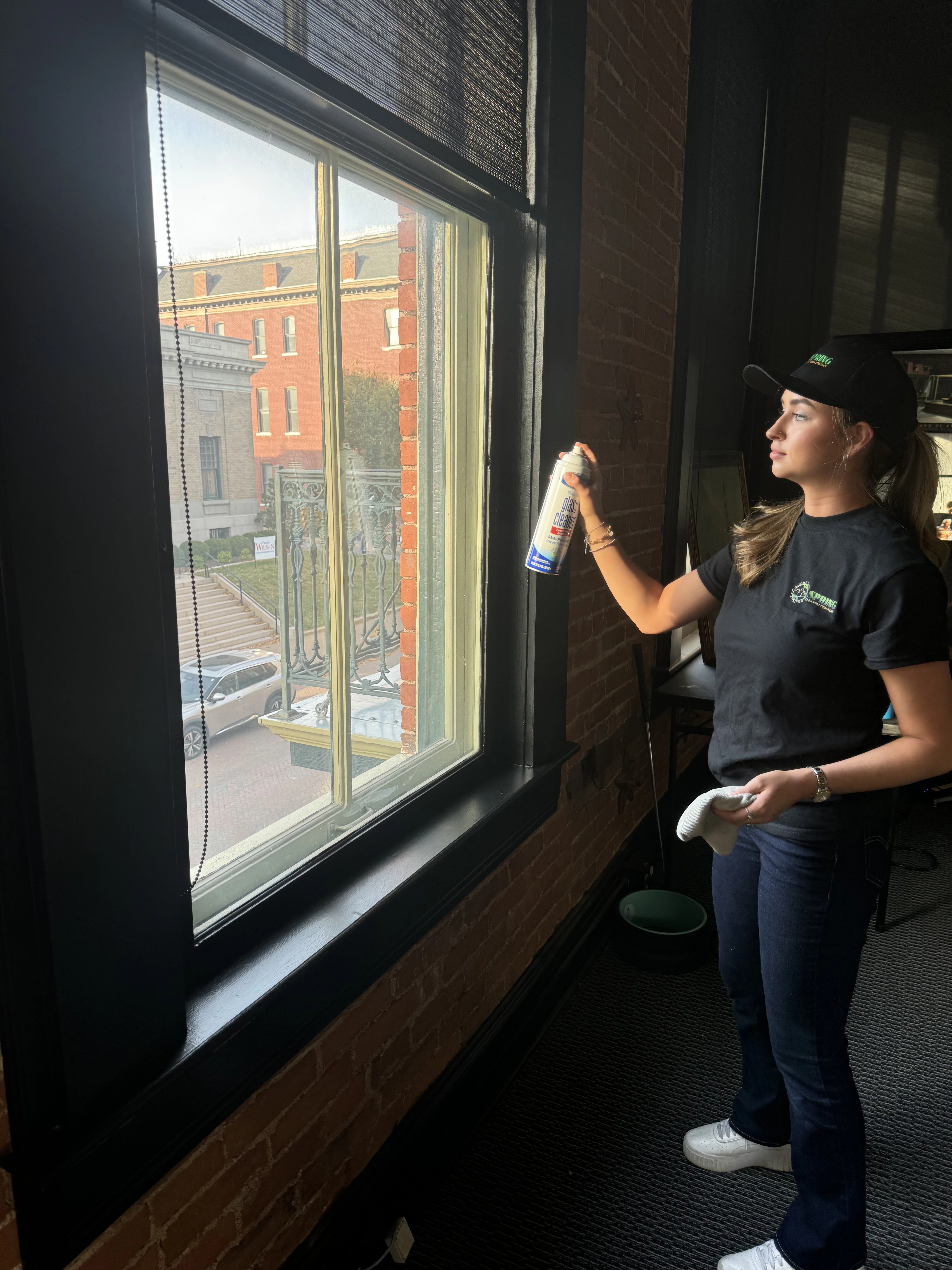 Spring Cleaning Company team member cleaning large interior windows of a commercial space in St. Louis, Missouri