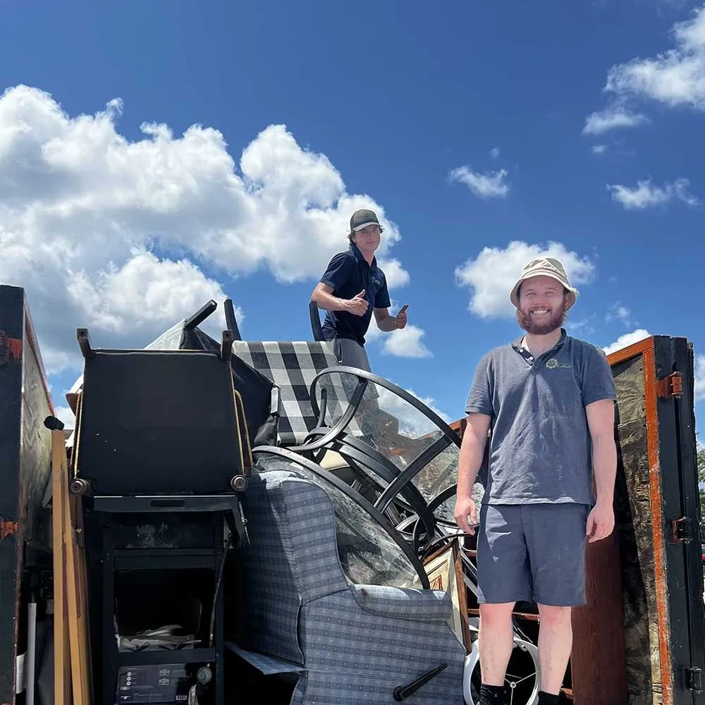 Spring Cleaning Company owners and staff inside truck full of junk collected from job site in St. Louis, Missouri
