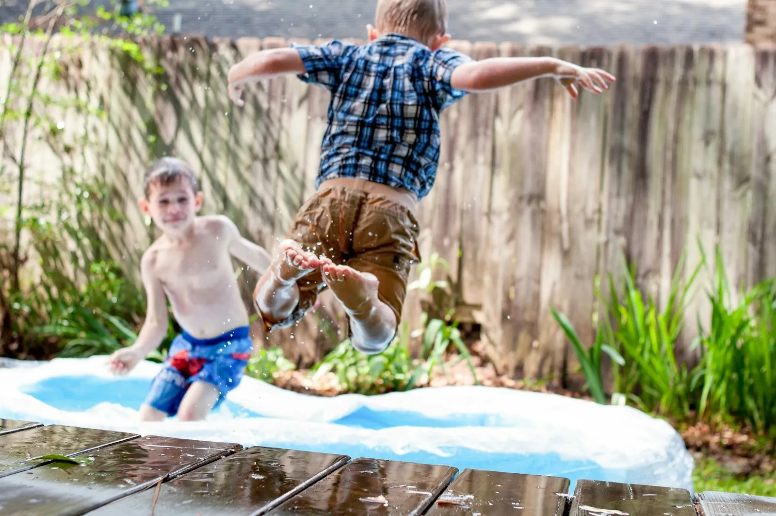 Clean backyard with children playing in inflatable pool after Spring Cleaning Company professional cleaning services in St. Louis, Missouri