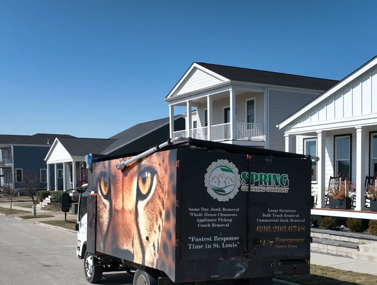 Spring Cleaning Company junk removal truck actively working in a residential neighborhood in St. Louis, Missouri