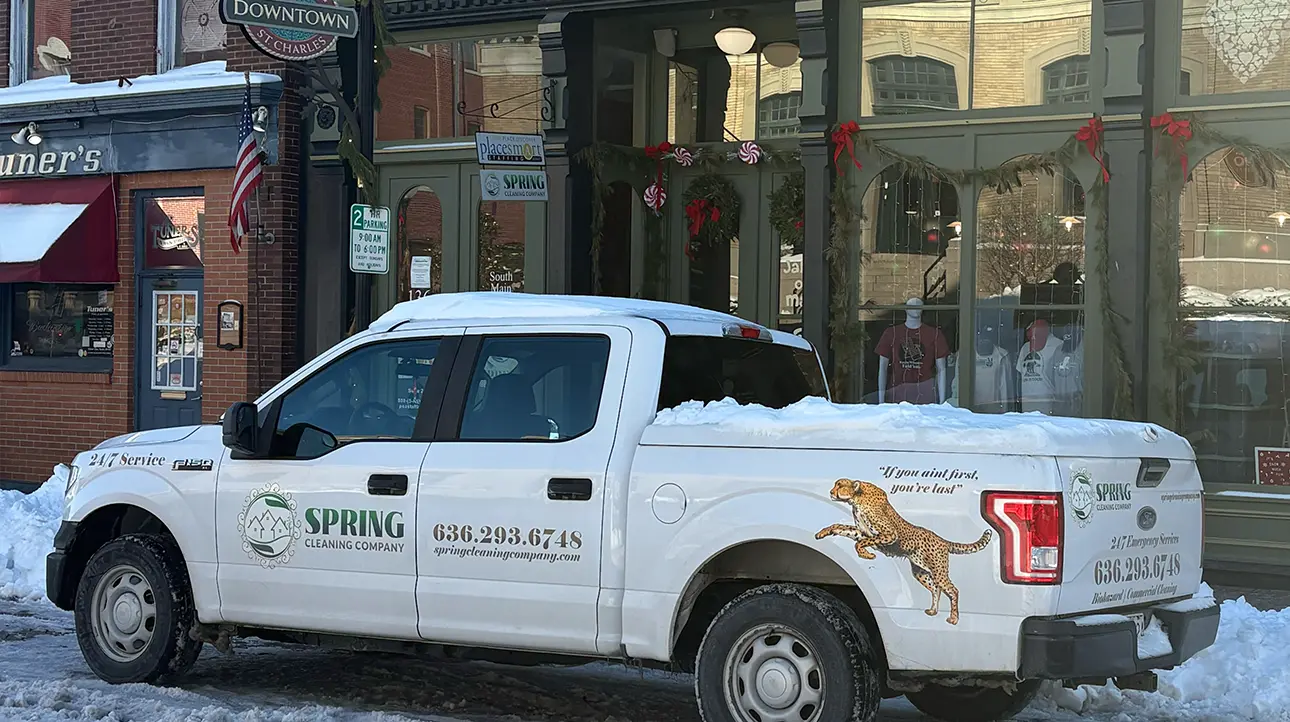 Spring Cleaning Company truck parked outside storefronts on a downtown street in St. Charles, Missouri