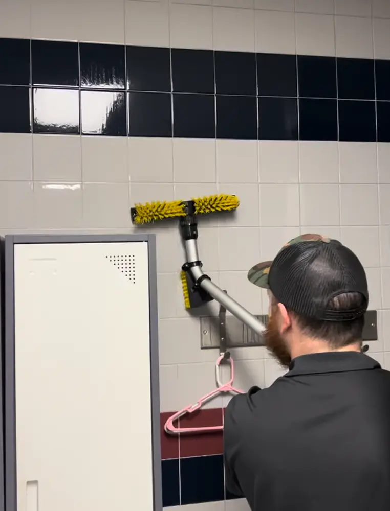 JunkItNow.com team member cleaning tile surfaces at a commercial space in St. Charles, Missouri